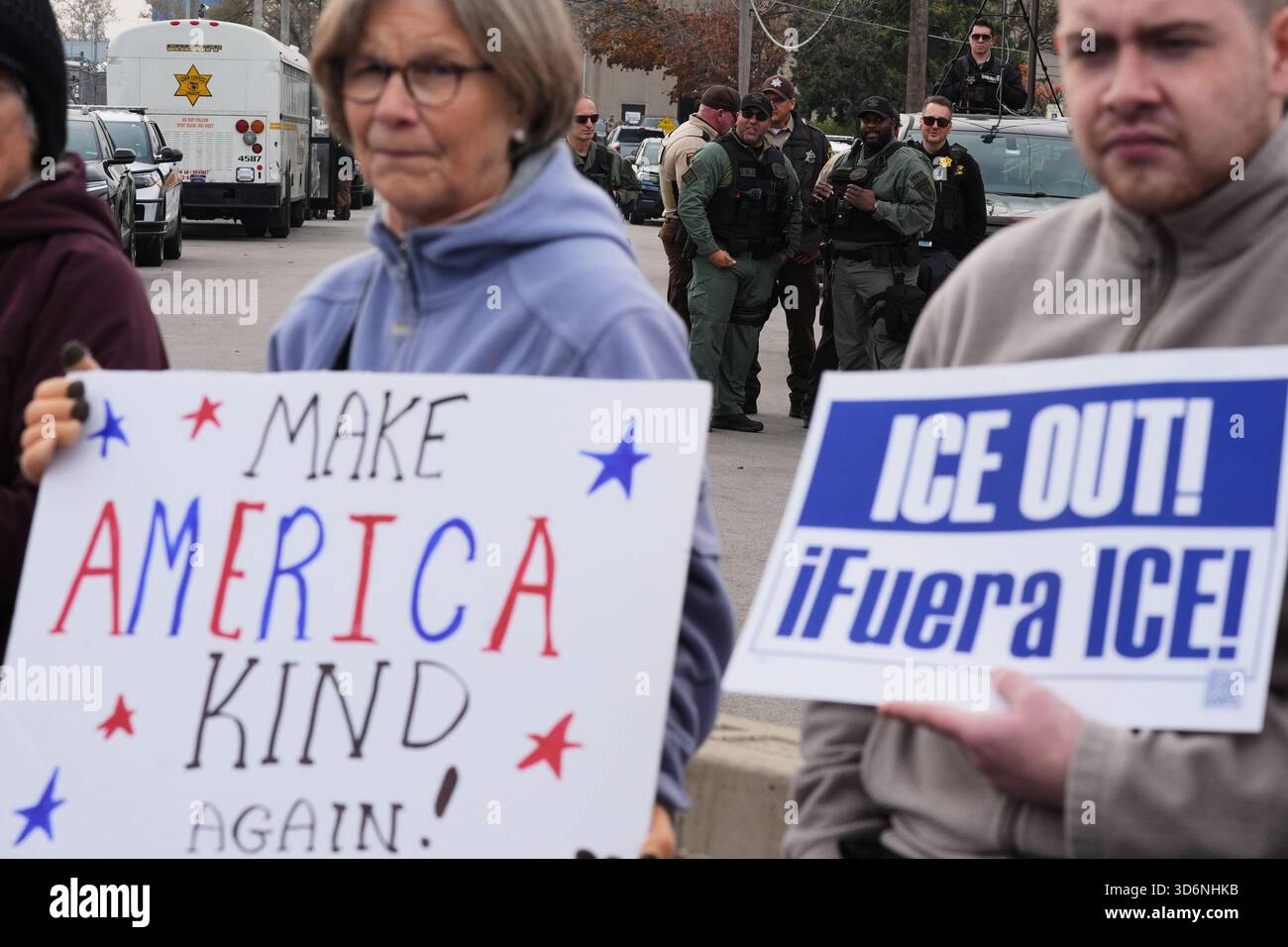Law enforcement officers guard as protesters gather outside an ICE ...
