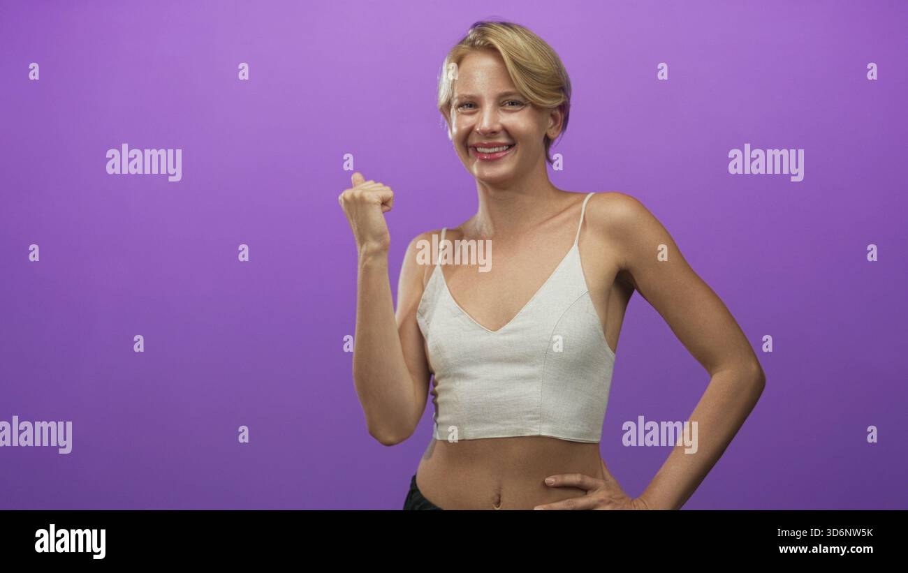 Blond woman making fist pump hi-res stock photography and images - Alamy