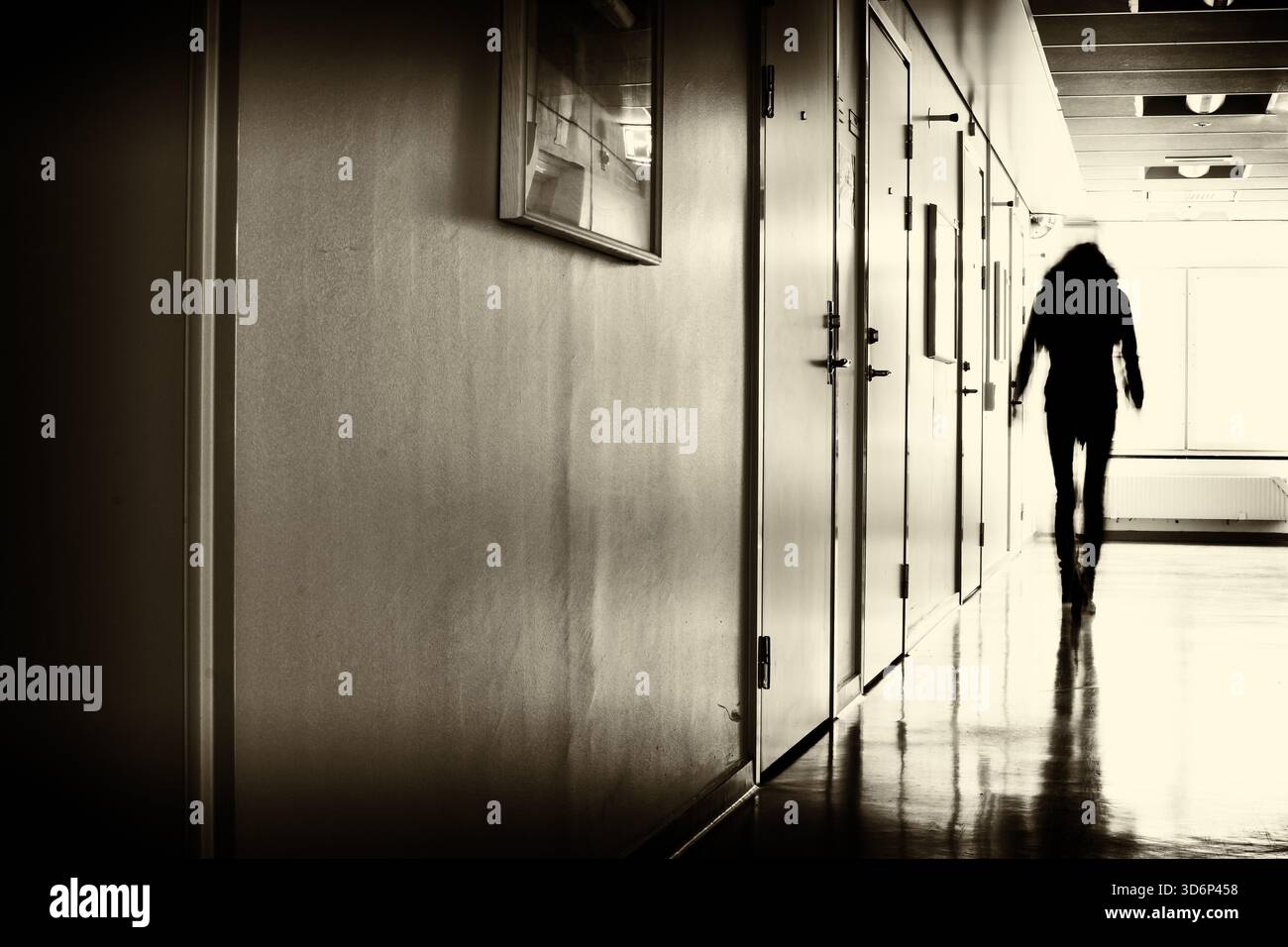 Metan Intutation Unrecognizable person in motion blur walking in a hallway at a mental ...