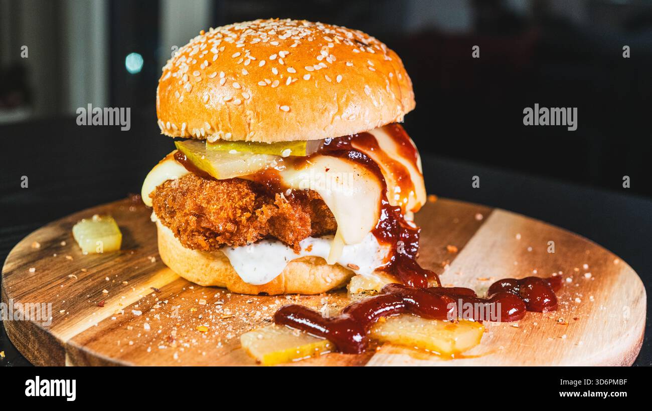 Crispy fried chicken katsu burger with tangy gherkins and special sauce ...
