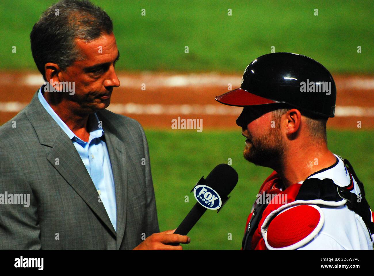 A television sportscaster interviews a catcher of the Atlanta Braves ...