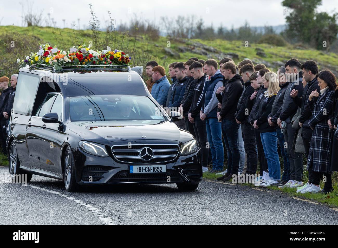 Mourners line the route as the hearse carrying the coffin of Shay Duffy ...