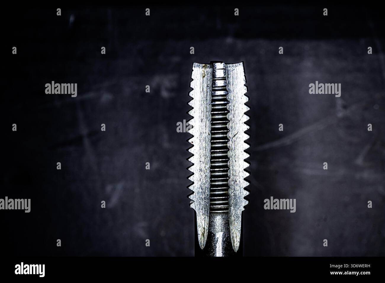 Close-up view of a metal thread tap showing detailed cutting edges and ...