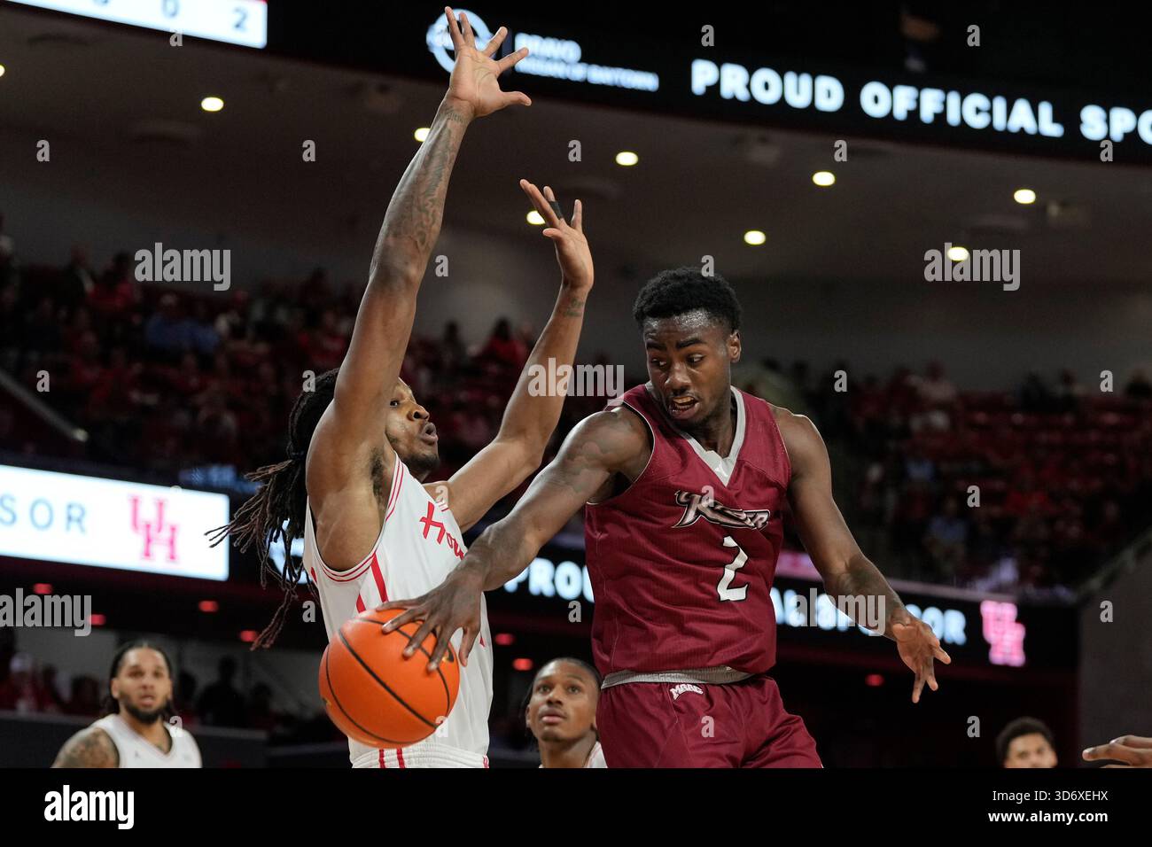 Caleb Rider Rider guard Caleb Smith (2) passes around Houston forward Joseph Tugler ...