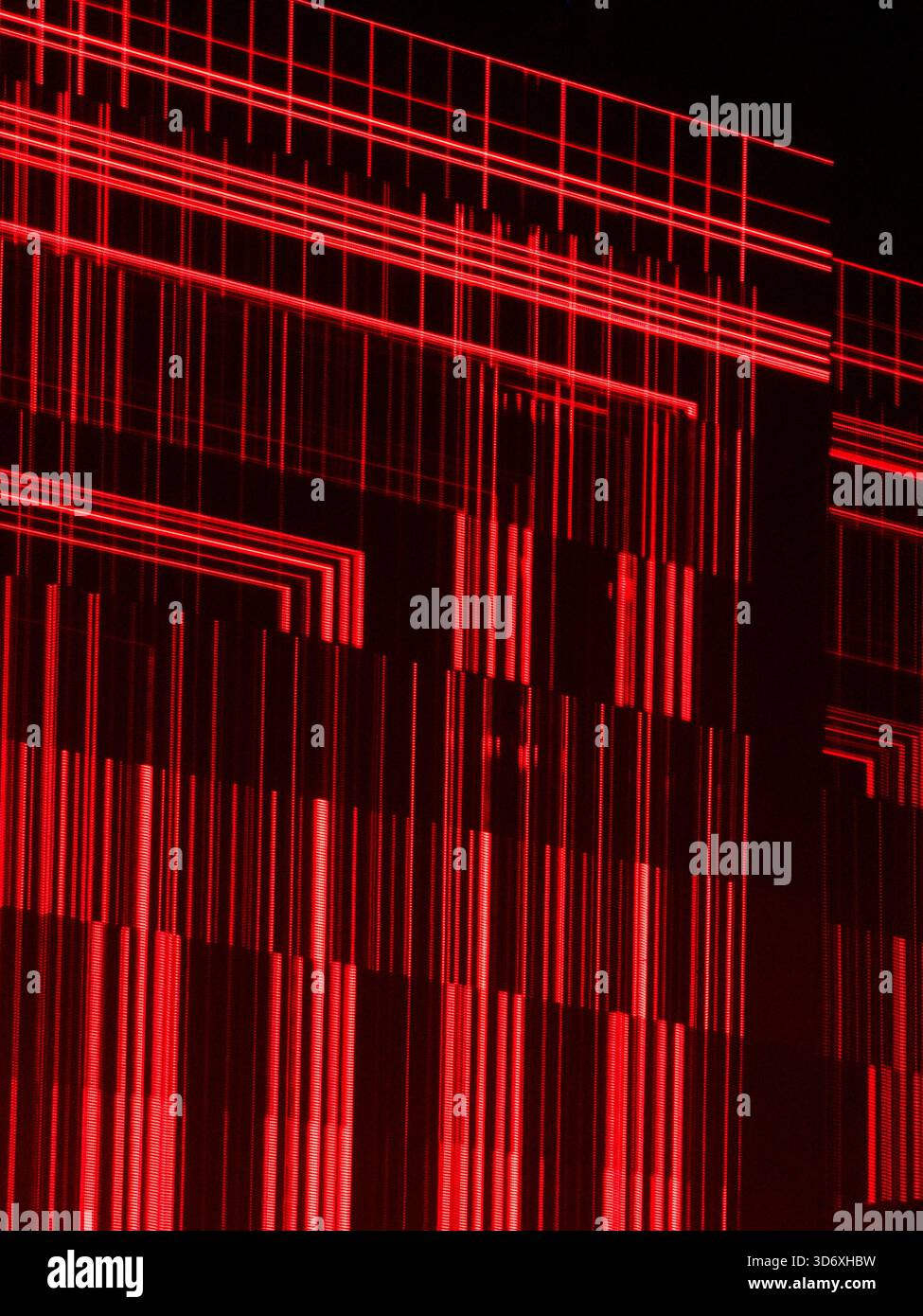 Abstract red laser light creating a grid pattern and vertical lines, representing data, computation, technology, science, and a futuristic digital con Stock Photo