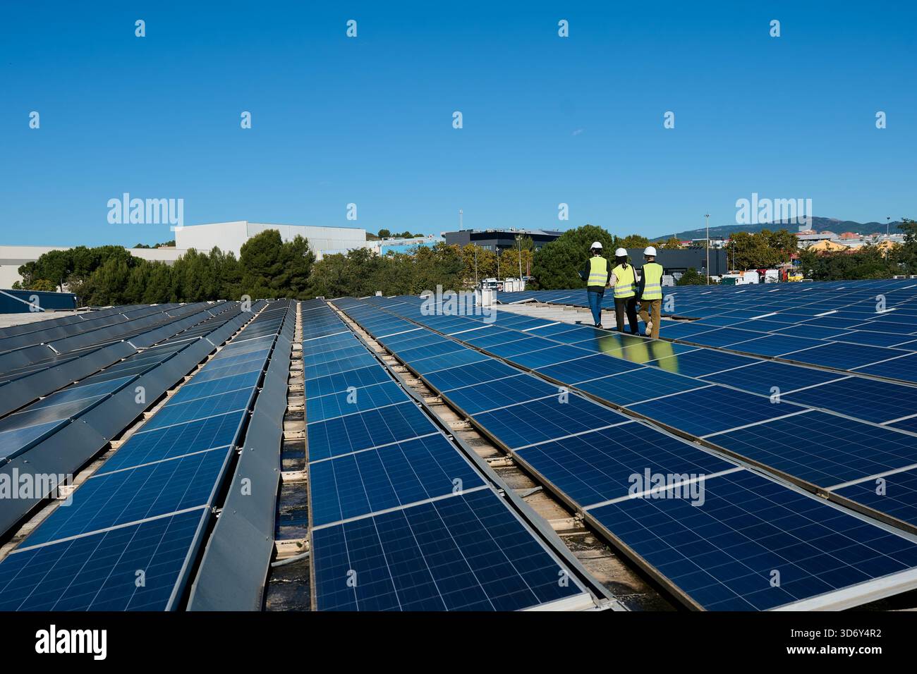 Picture of Engineers inspecting rooftop solar panel installation for renewable ...
