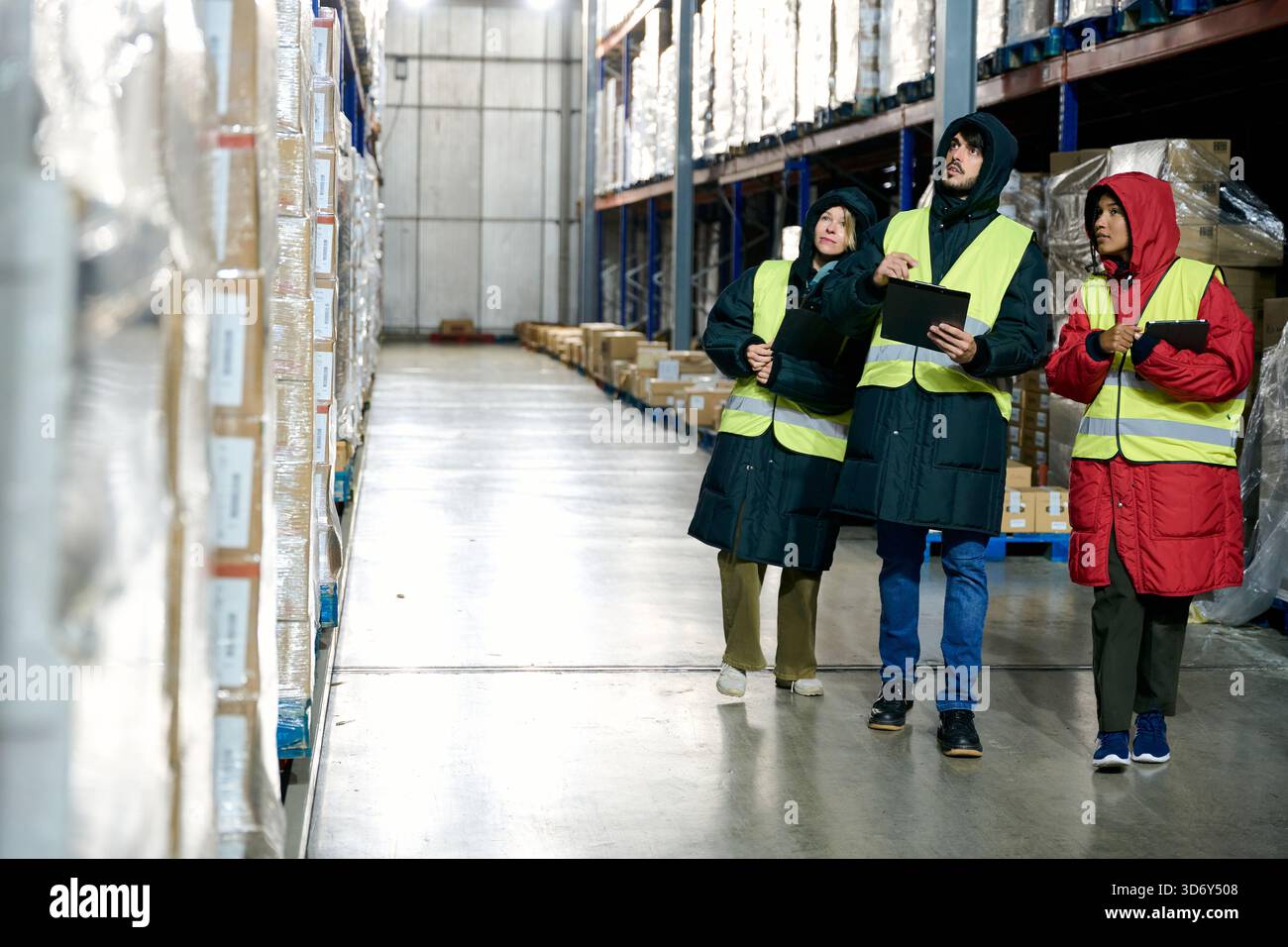 Cold chain workers checking inventory in large warehouse Stock Photo