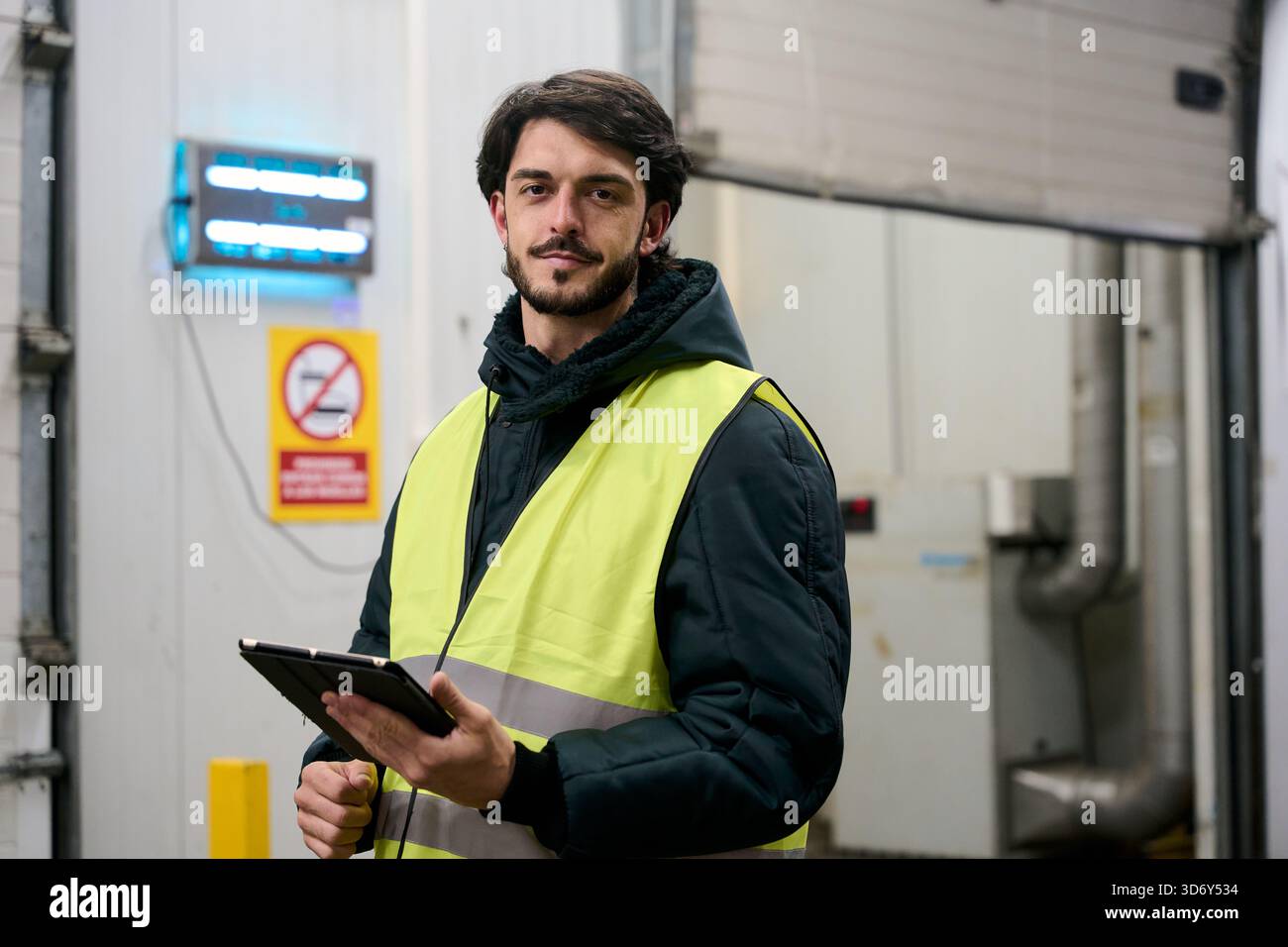 Warehouse worker inspecting cold chain inventory management using tablet Stock Photo