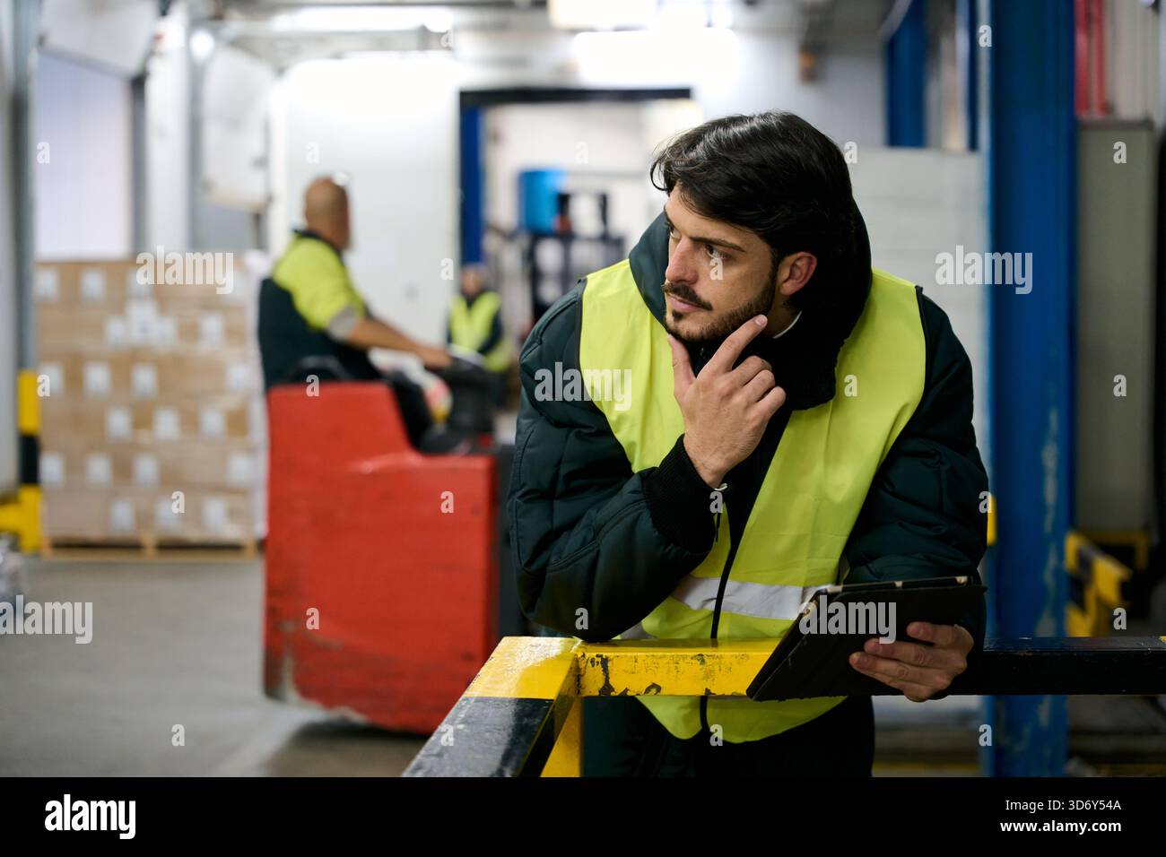 Logistics manager thinking about inventory control in cold chain warehouse Stock Photo