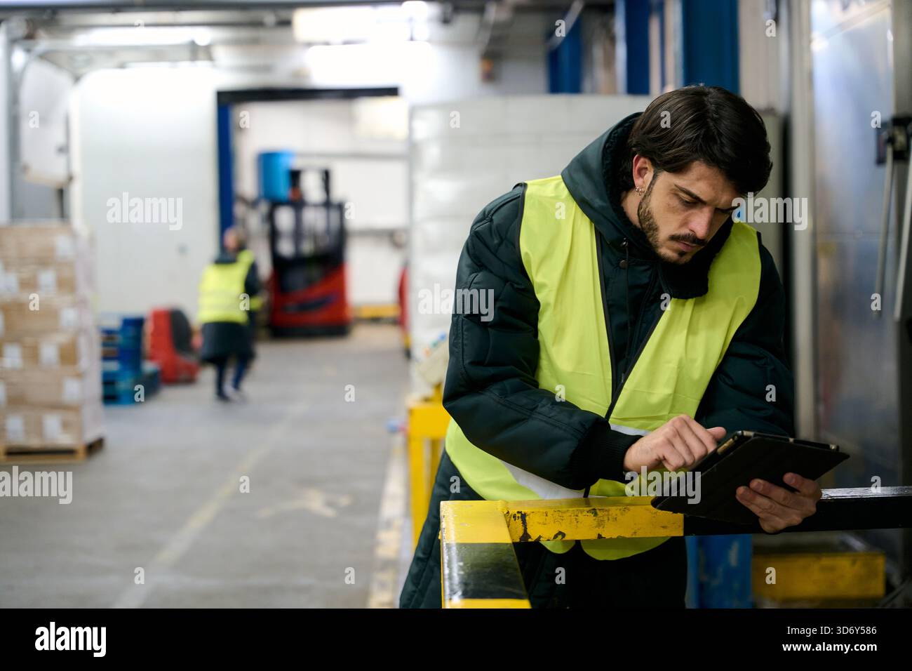 Worker managing cold chain logistics using tablet Stock Photo