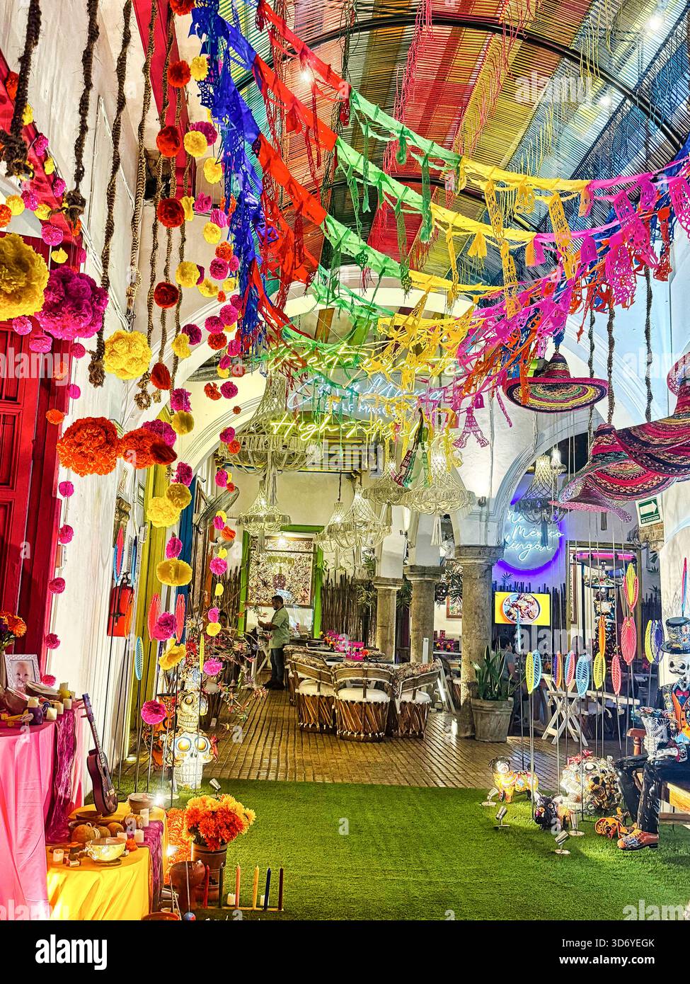 An altar is decorated with the flowers and offerings and other decorations for Mexico's Day of the Dead festival in a shopping center at Merida Stock Photo