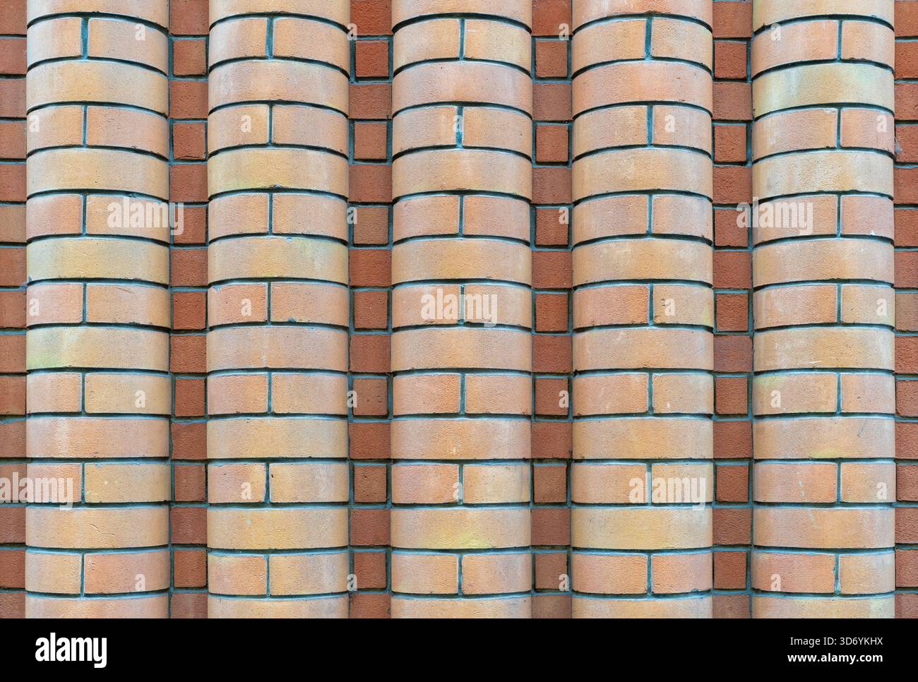 Old wall of curved bricks Stock Photo