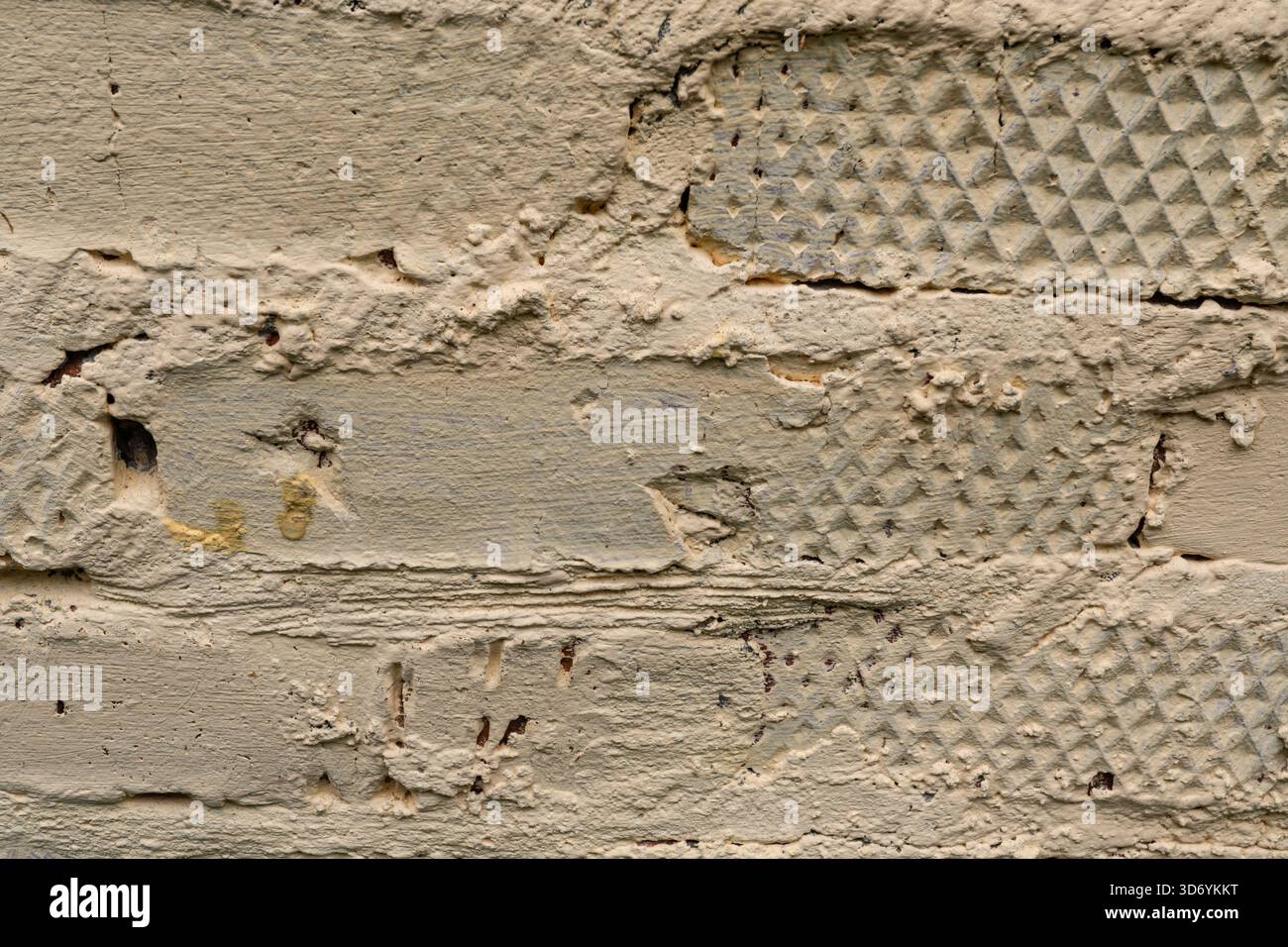 Textured beige painted brick wall with patterned surface detail Stock Photo