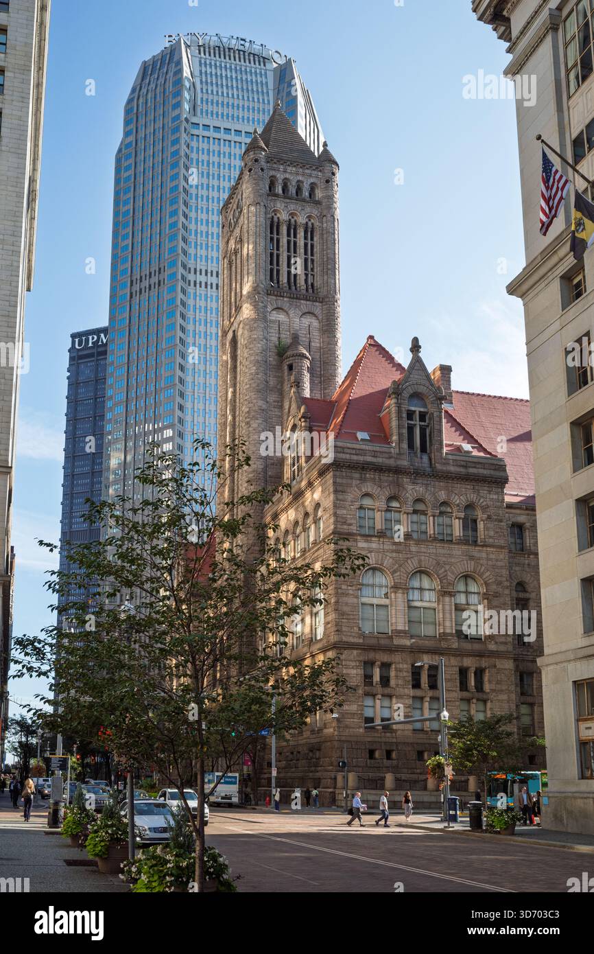 Historic Allegheny County Courthouse tower contrasting with a modern skyscraper in downtown Pittsburgh, Pennsylvania. Stock Photo