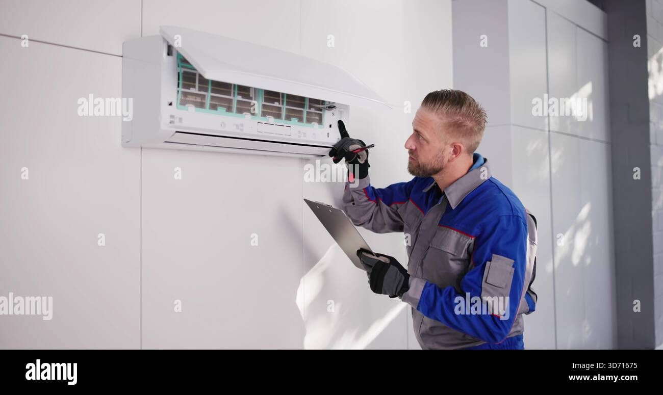Professional HVAC Technician Installing Air Conditioner On Rooftop, Checking Efficiency. Stock Photo