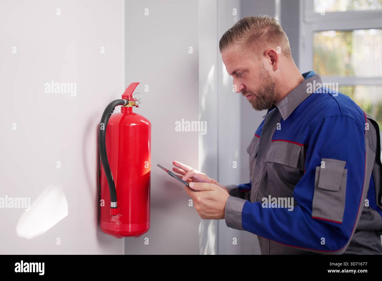Ensuring Security By Installing Emergency Fire Extinguisher In Antique Store Stock Photo