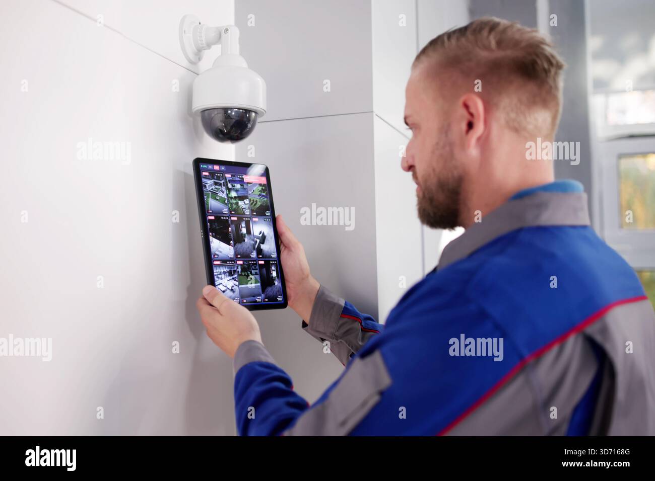 Tech Expert Enhances Office Security With Video Surveillance Installation Service. Stock Photo