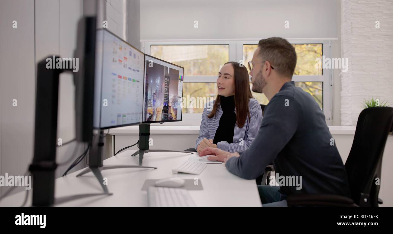 Two Graphic Designers Working On Computer For Print And Web. Stock Photo