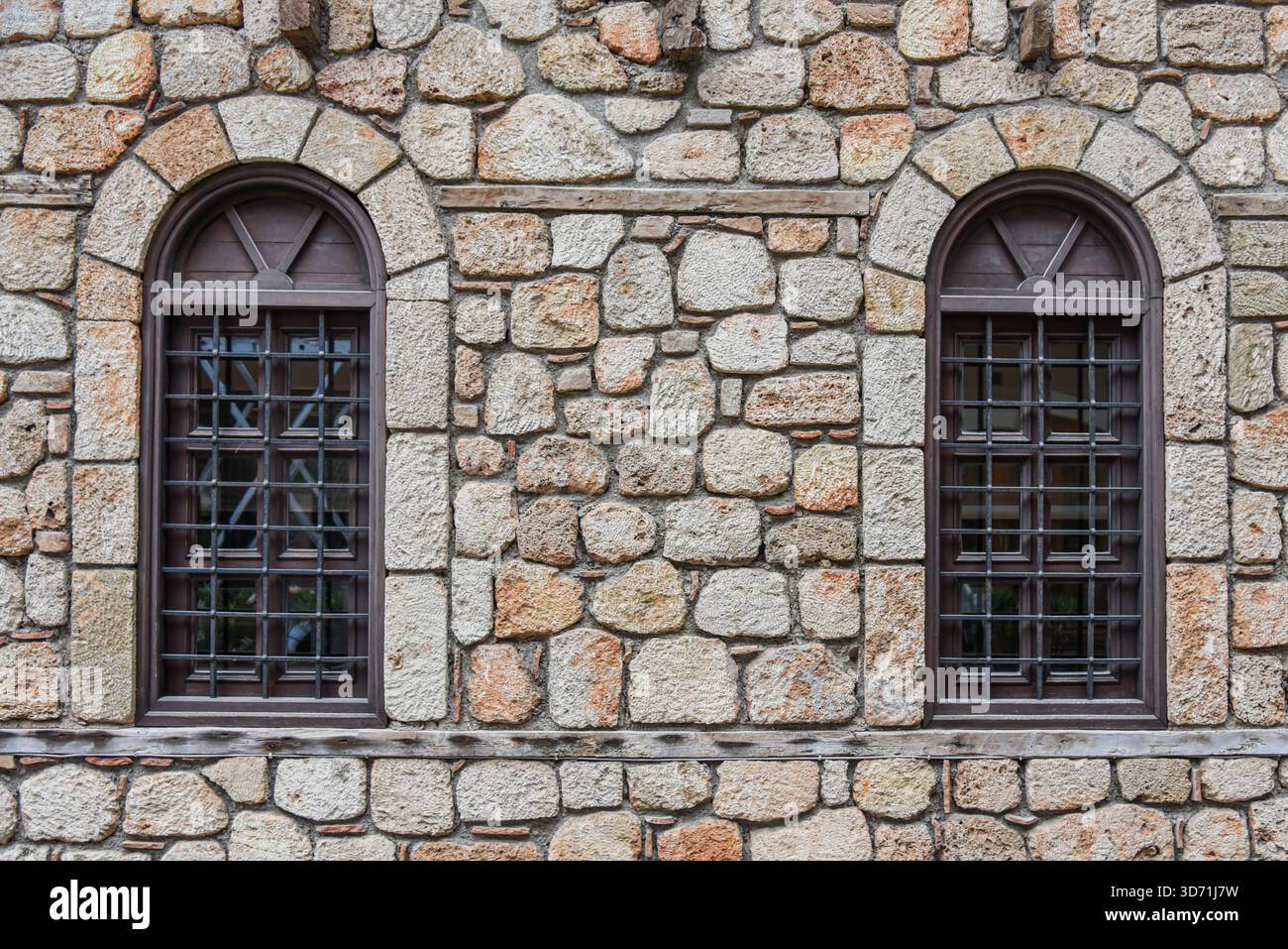 Symmetrical Arched Windows in a Stone Masonry Wall Stock Photo - Alamy
