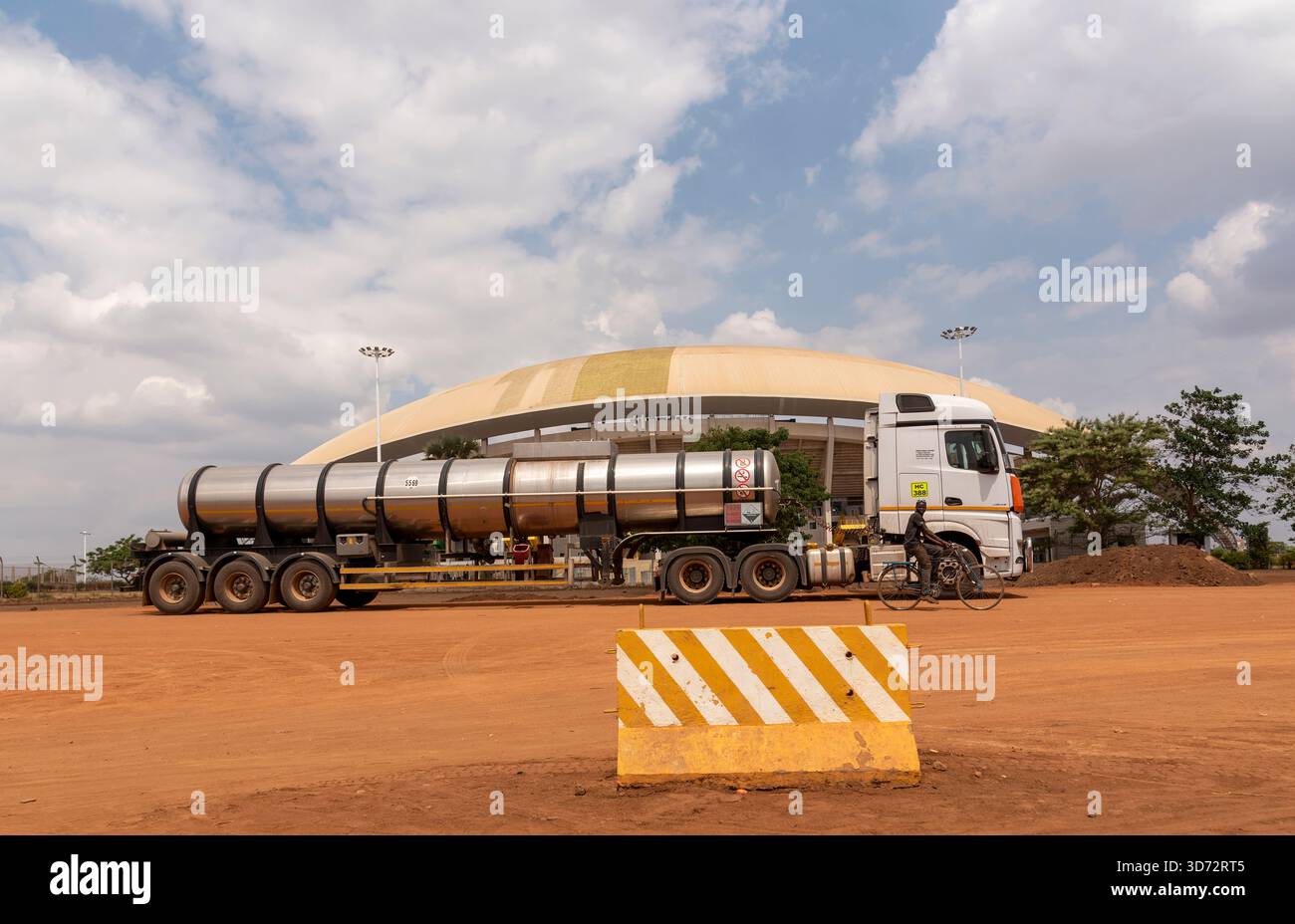 Lilongwe Malawi Africa. 08.11.2025.  Articulated  fuel truck passing the Bingu National Stadium on a dirt road in Lilongwe capital of Malawi Africa. - Stock Image
