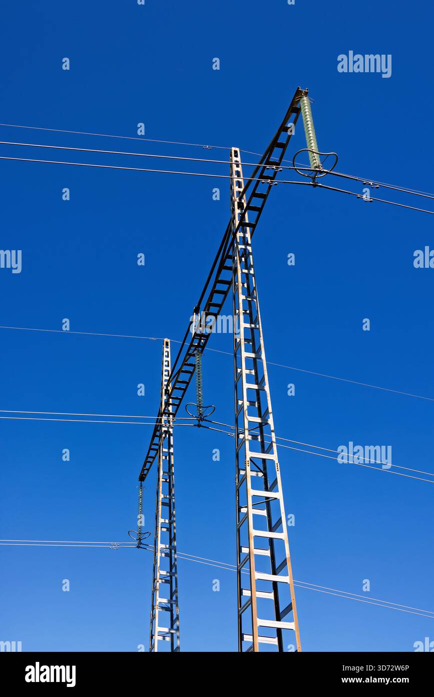 High voltage power line tower at a blue sky Stock Photo