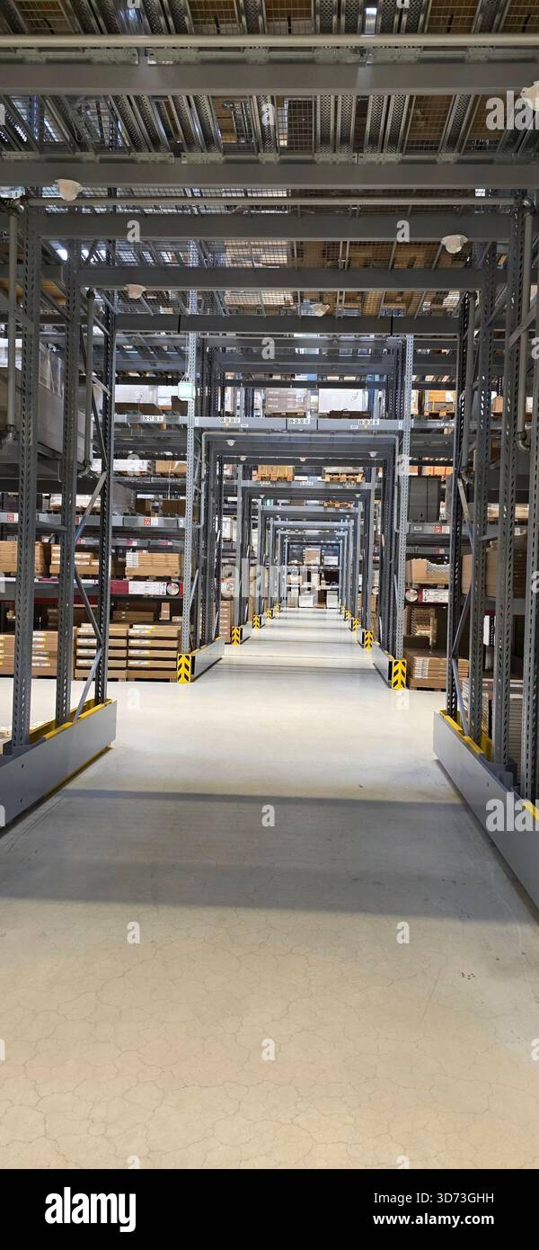 Interior view of warehouse showcasing organized shelves and clear pathways for storage efficiency. - Smartphone Captured Stock Image