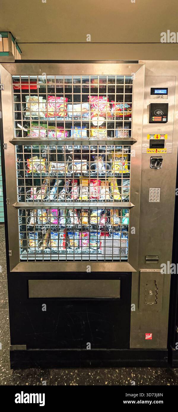 Berlin, Germany - July 11, 2025: . Vending machine displays various snacks and drinks in a contemporary indoor environment - Smartphone Captured Stock Image