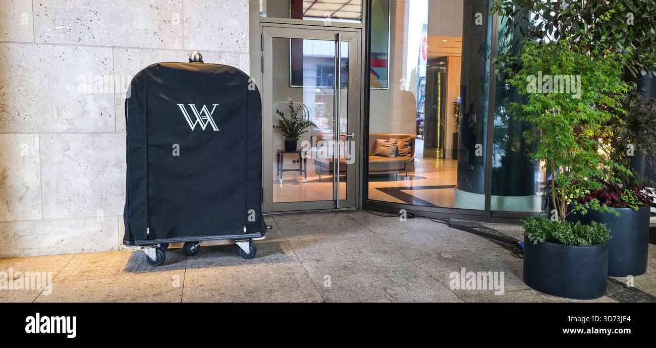 Berlin, Germany - July 17, 2025: . Hotel luggage cart is positioned outside the entrance in a contemporary environment - Smartphone Captured Stock Image