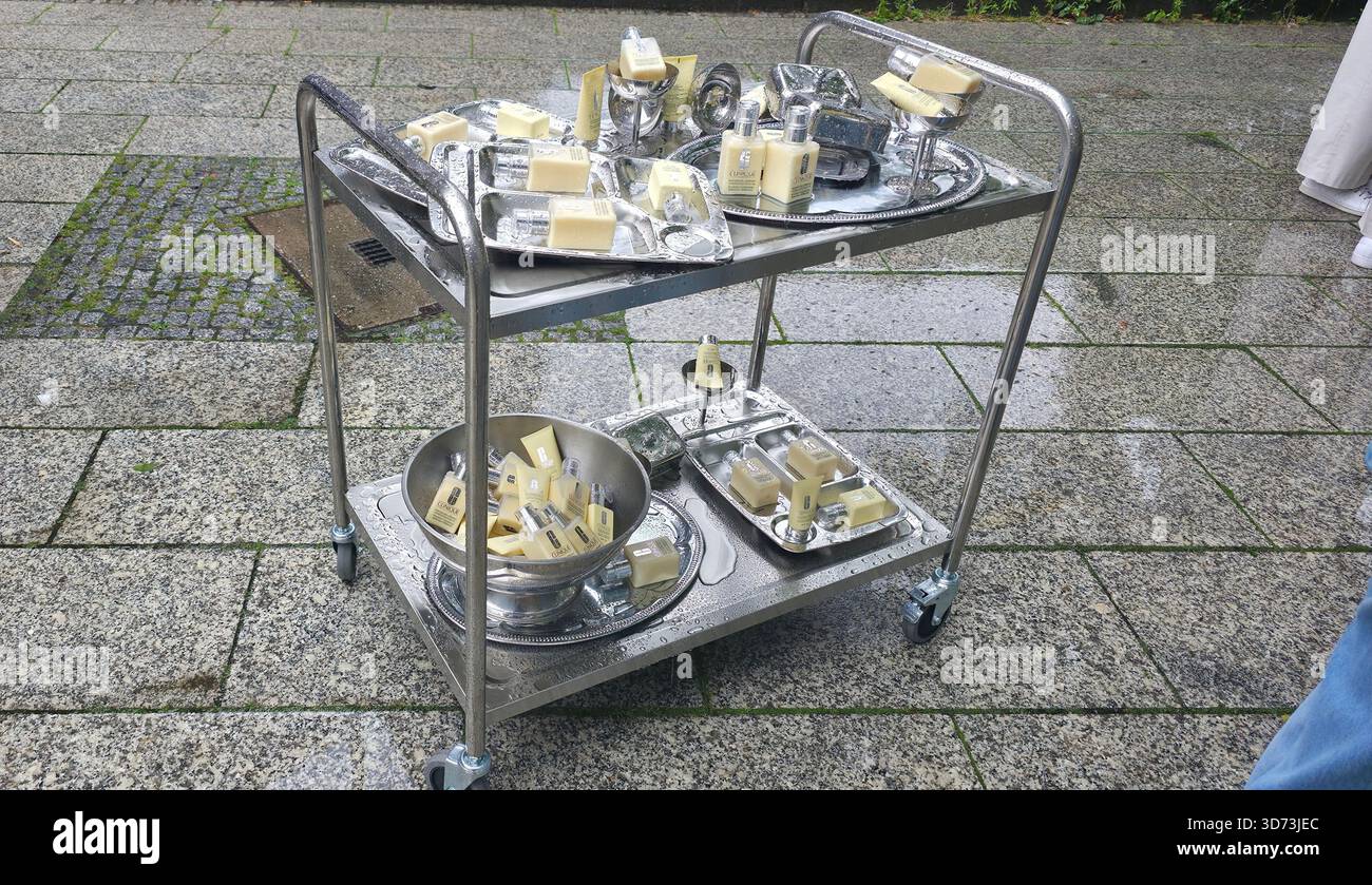 Berlin, Germany - July 17, 2025: . Stainless steel cart showcases various soap bars arranged outdoors on pavement - Smartphone Captured Stock Image