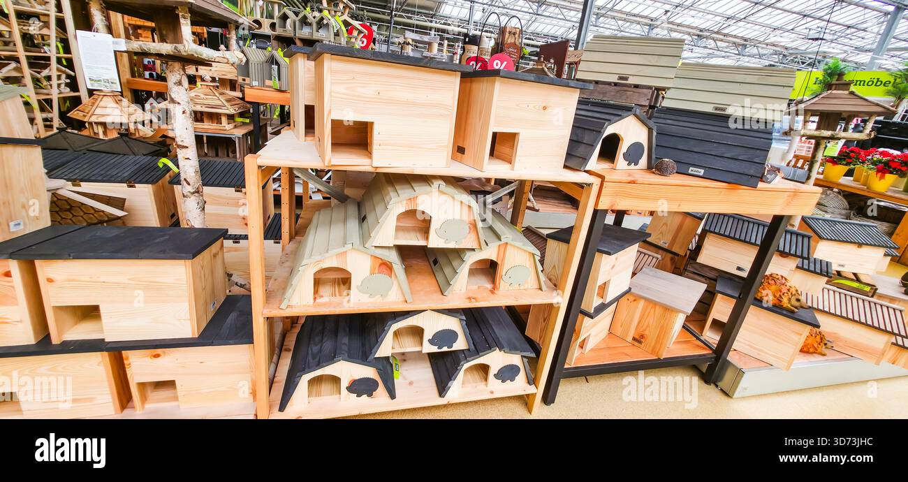 Berlin, Germany - August 06, 2025: . Wooden birdhouses are arranged on shelves in a garden center for outdoor decoration - Smartphone Captured Stock Image