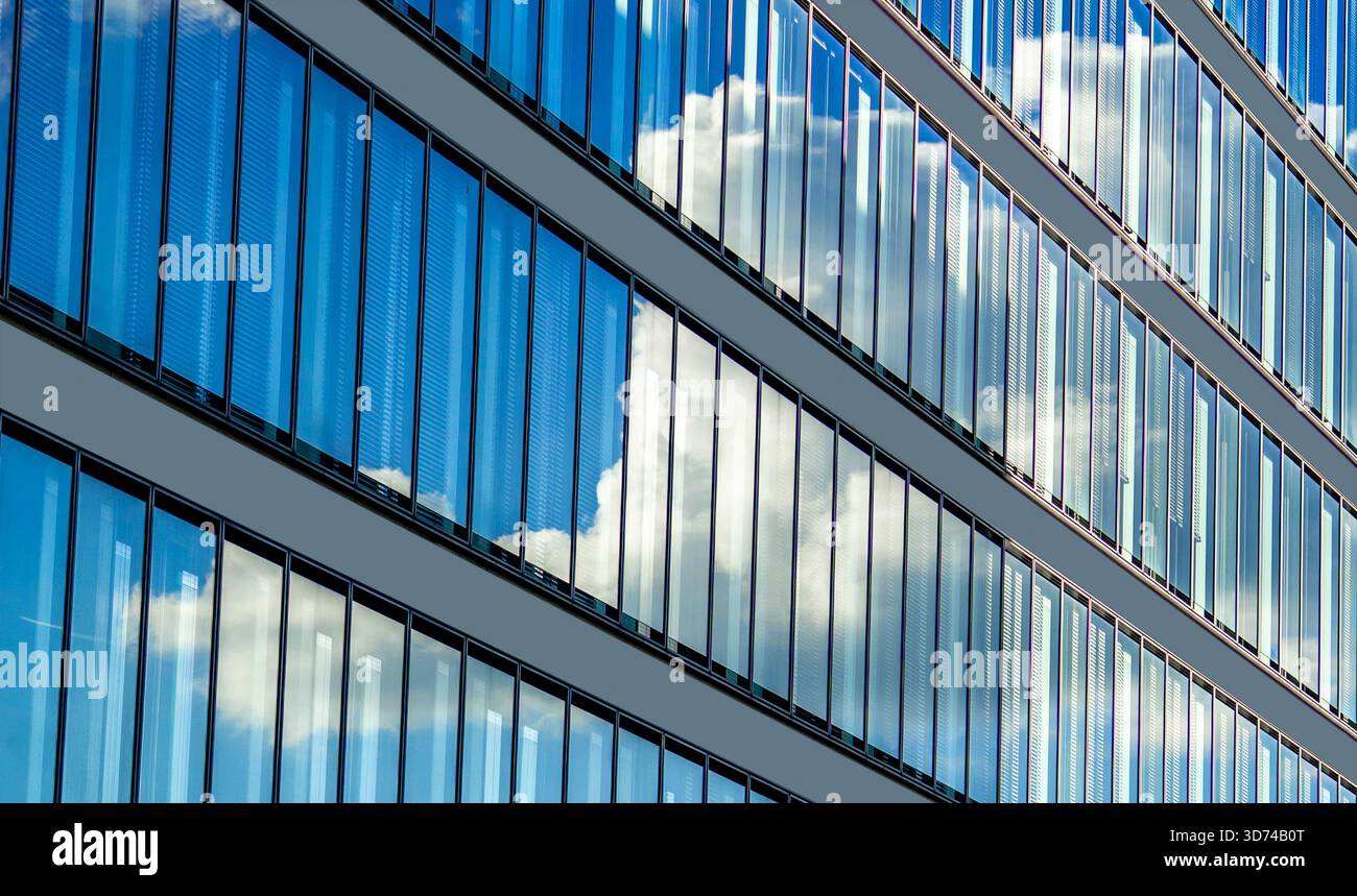 Clouds reflecting in modern glass facade of an office building. Foreign ...