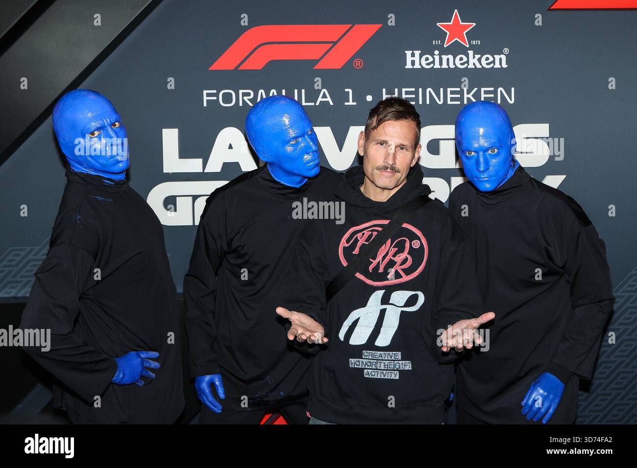 November 22, 2025: Members of the Blue Man Group pose with DJ Kaskade ...