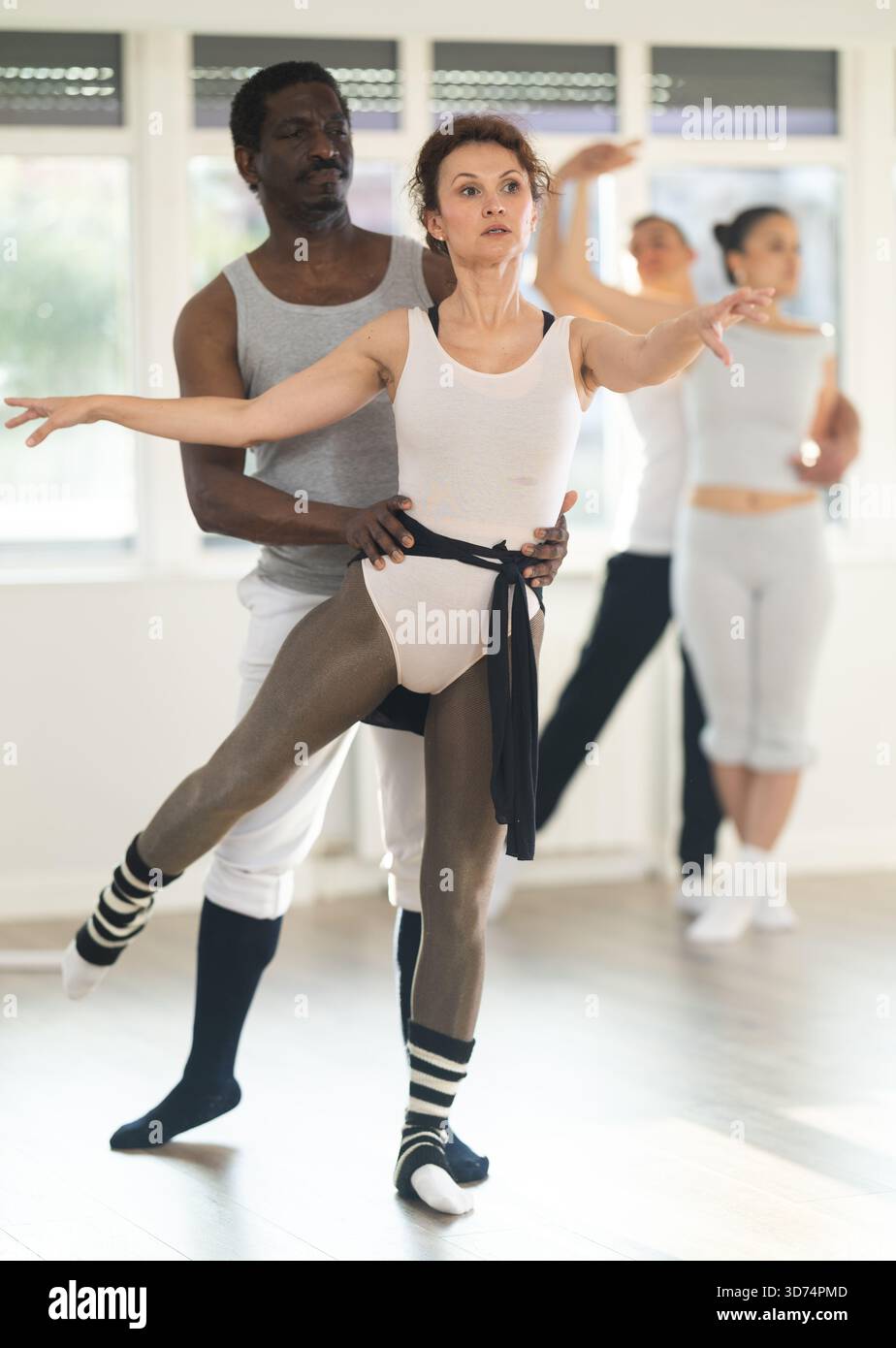 Ballet partners performing elegant dance sequence in studio Stock Photo ...
