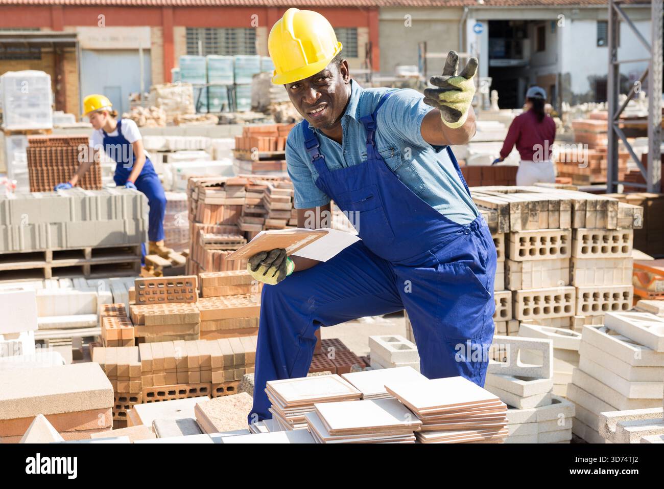 Builder is choosing ceramic tiles in building store Stock Photo