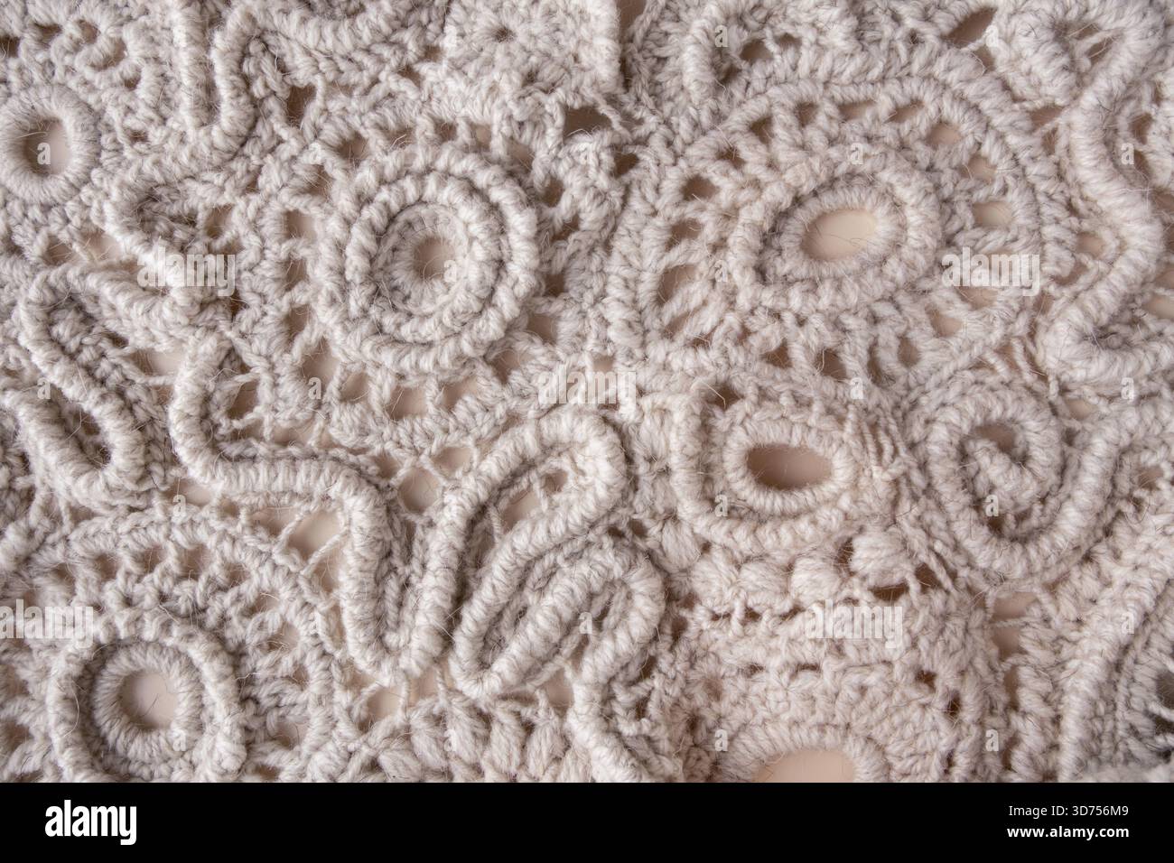 Hand-knitted lace made from wool threads, textured background Stock Photo
