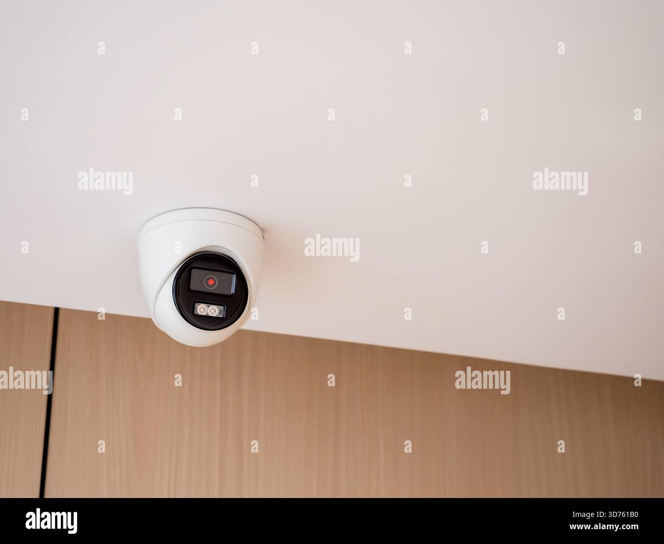 Indoor security camera mounted on ceiling in modern building ...