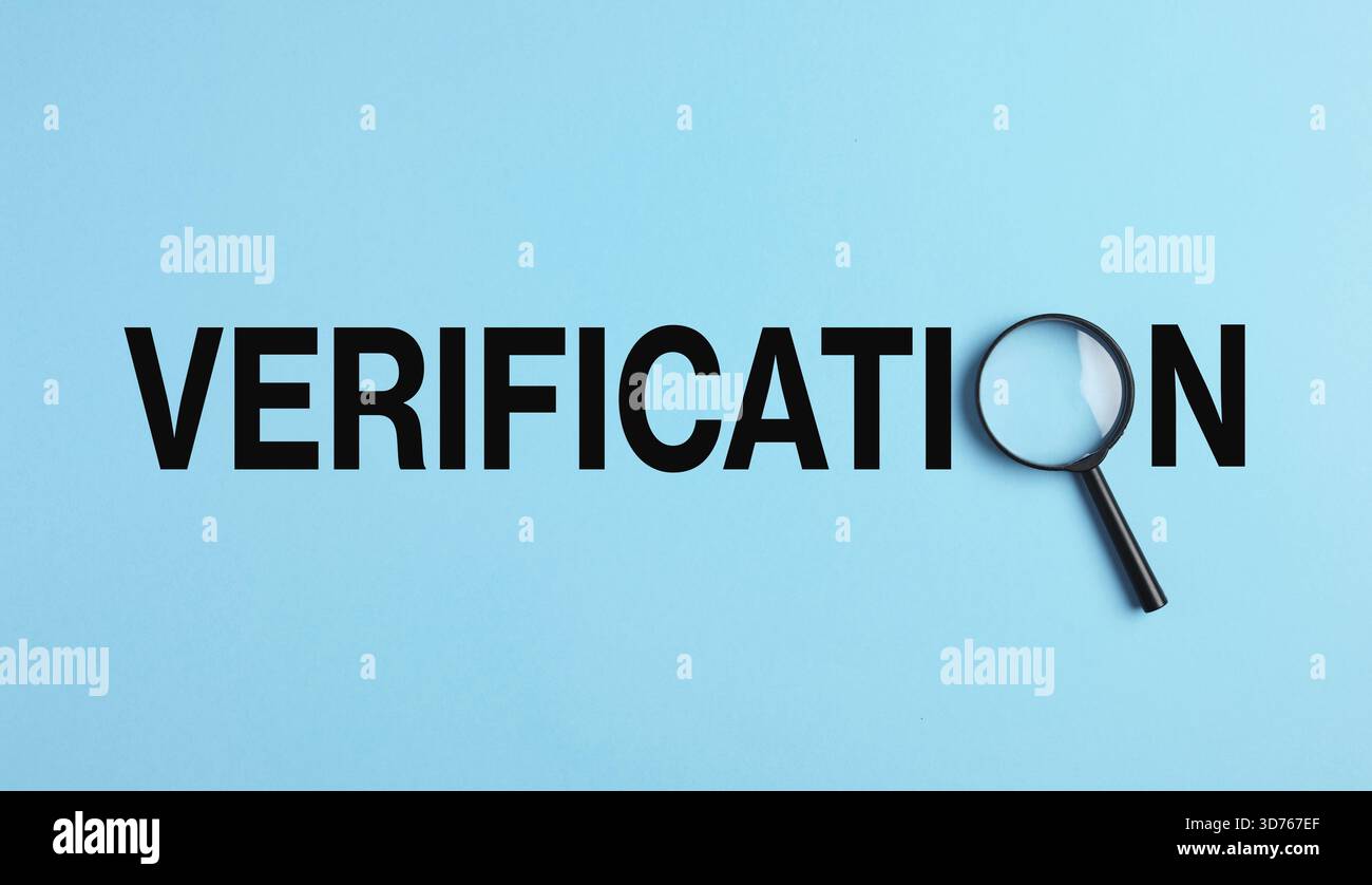 Verification word spelled out in black letters with magnifying glass on blue background analyzing text Stock Photo