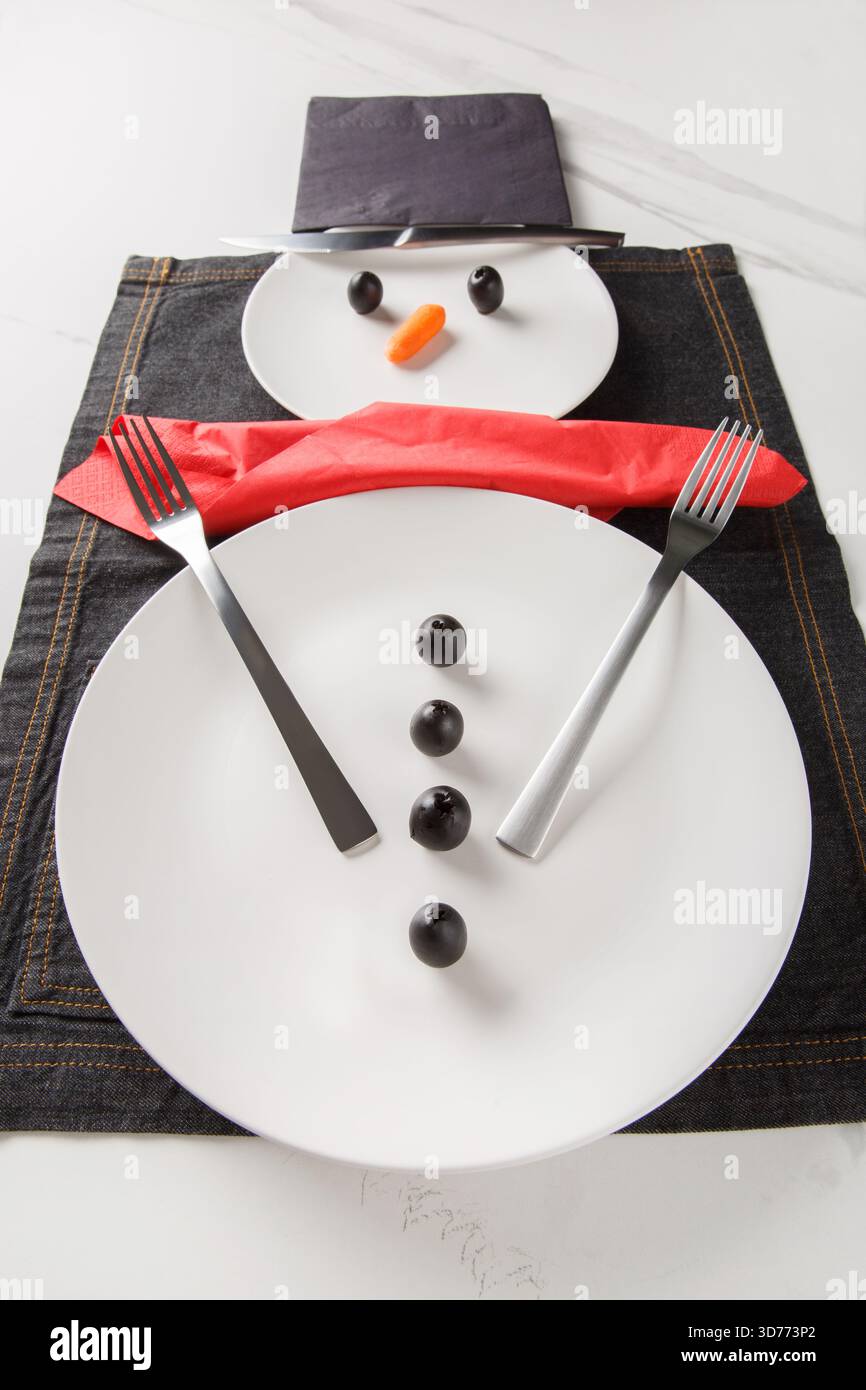 Christmas or New Year's table setting idea: snowman composition. Vertical Stock Photo