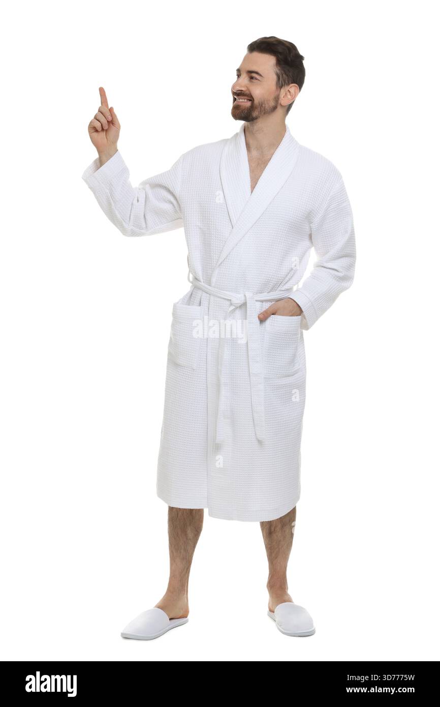 Man in bathrobe pointing at something on white background Stock Photo