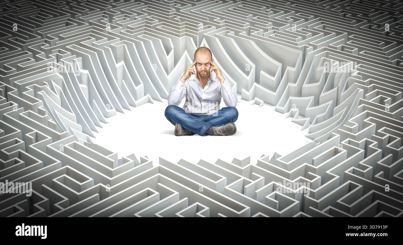 Man lotus position thinking about solution maze labyrinth Stock Photo