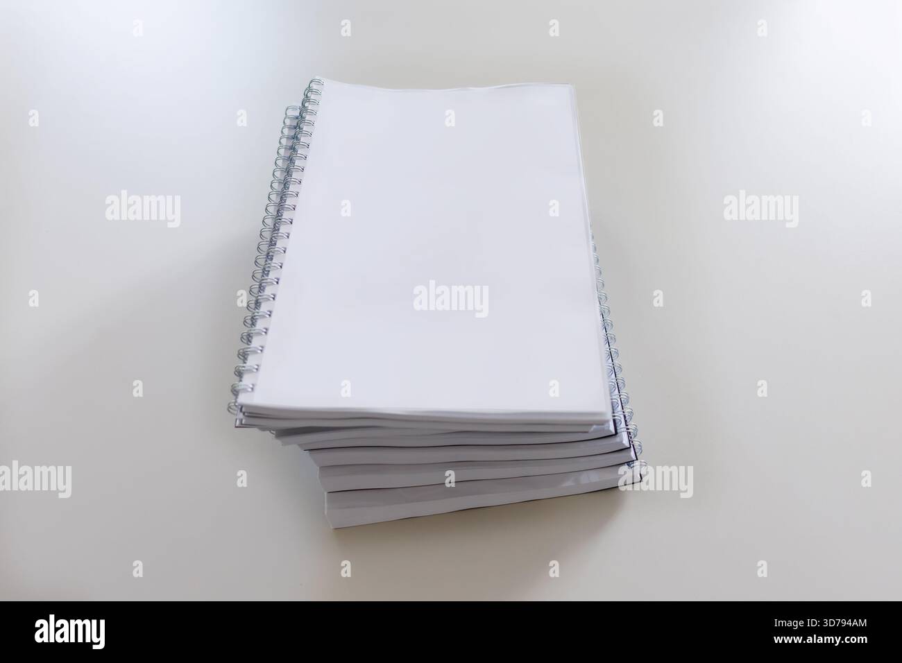 stack of blank spiral notebooks ready for writing at a clean workspace Stock Photo
