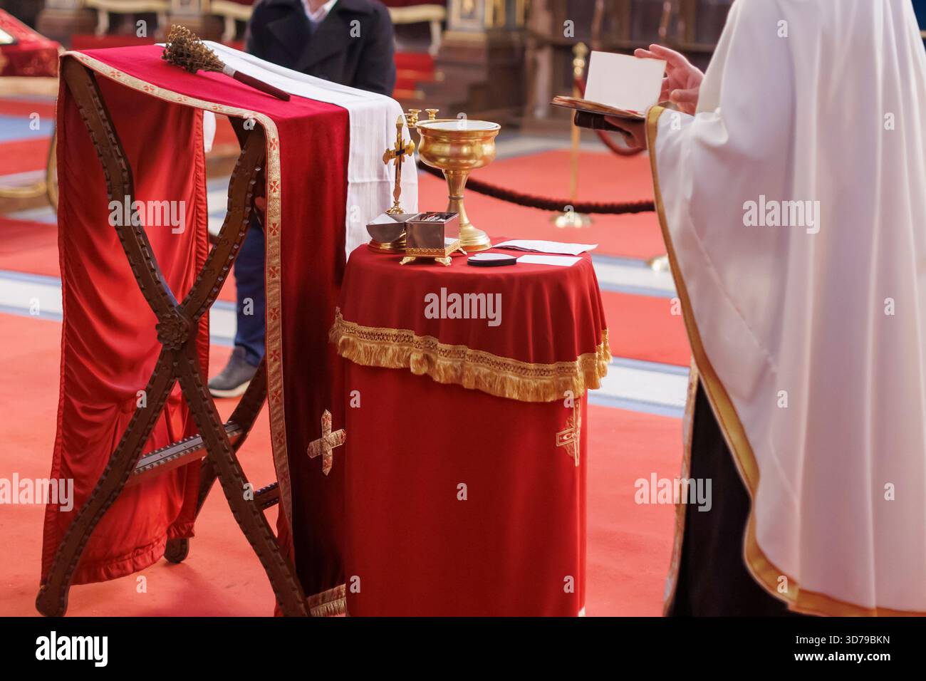 ceremony being performed in Orthodox church by a priest Stock Photo