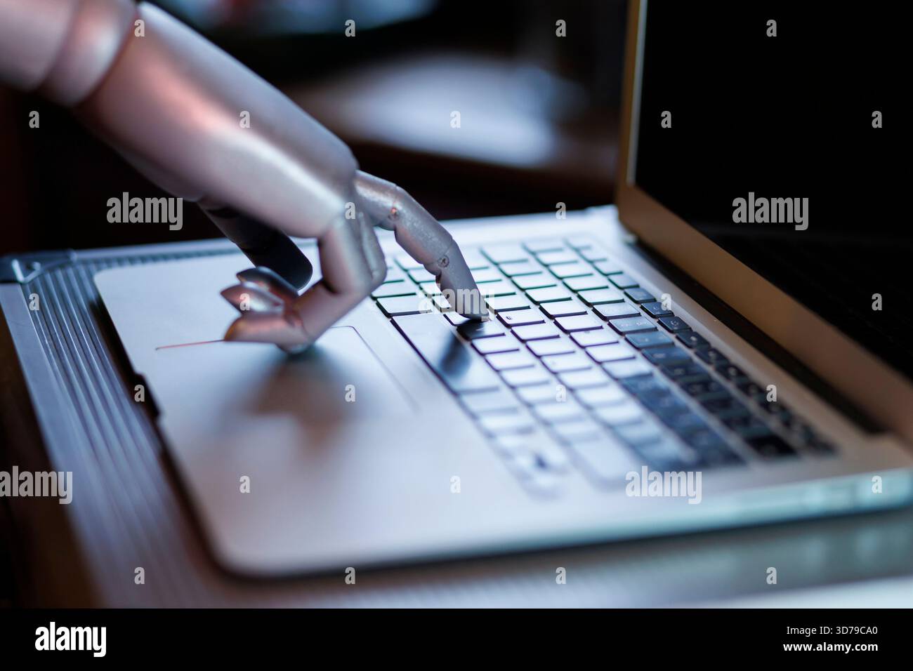 Robot hand interacting with laptop keyboard Stock Photo