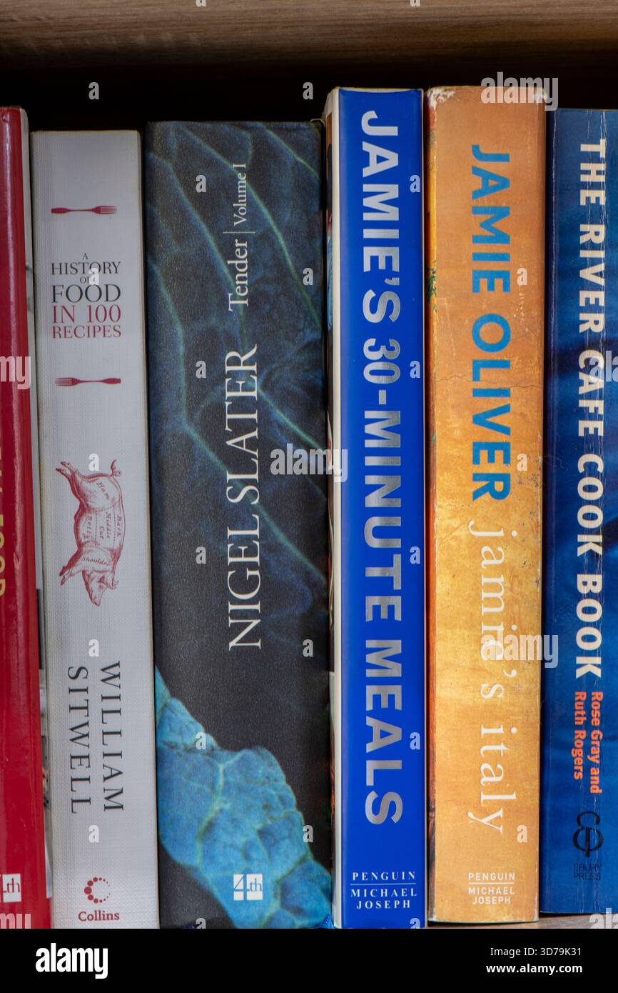 selection of celebrity chef cookery books on a kitchen shelf. Colourful cookery book bindings on bookshelf. Stock Photo