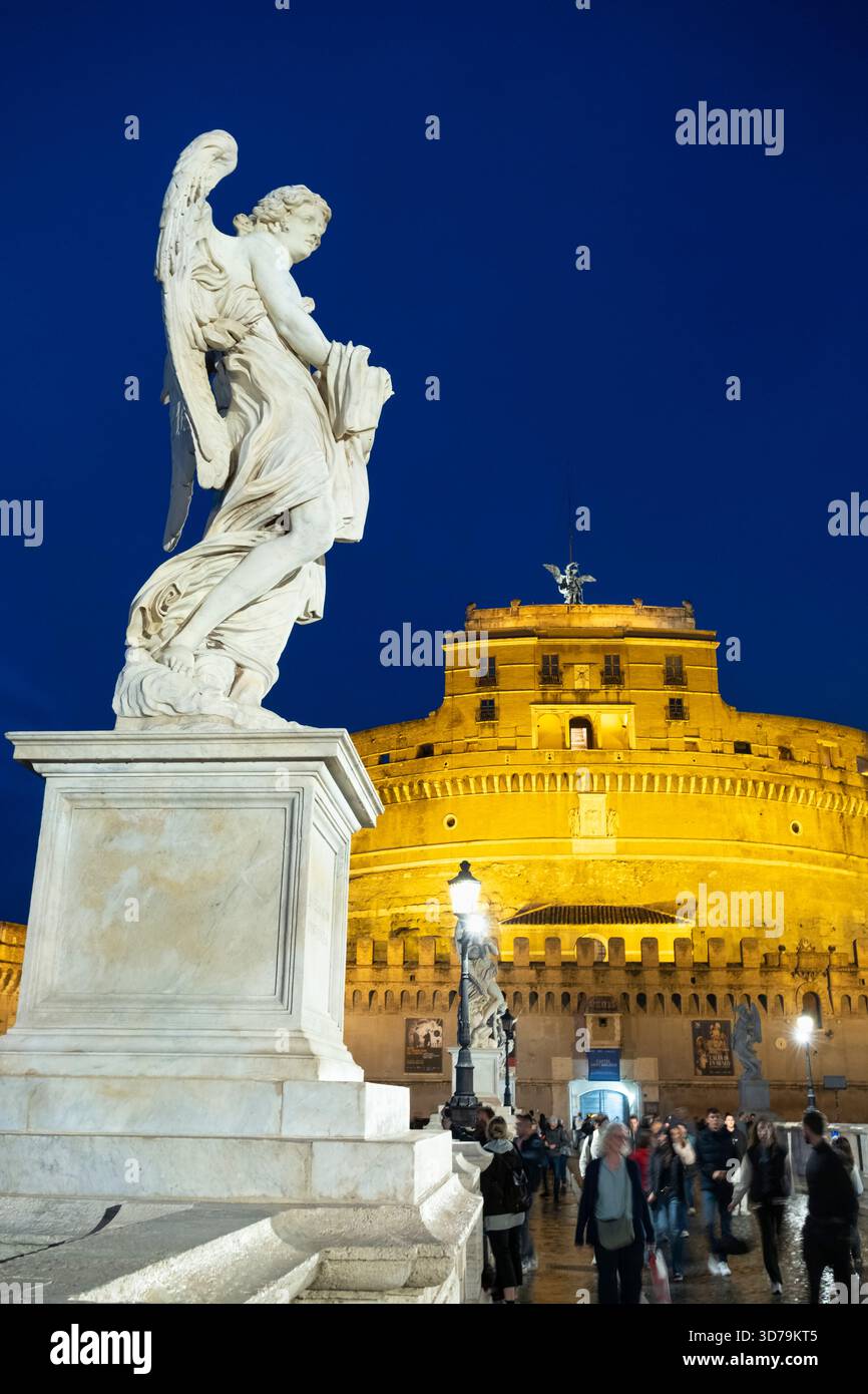Floodlit Statues of angels, at night, on the Ponte Sant'Angelo, with the Castel Sant'Angelo in the background. Rome, Italy. Stock Photo