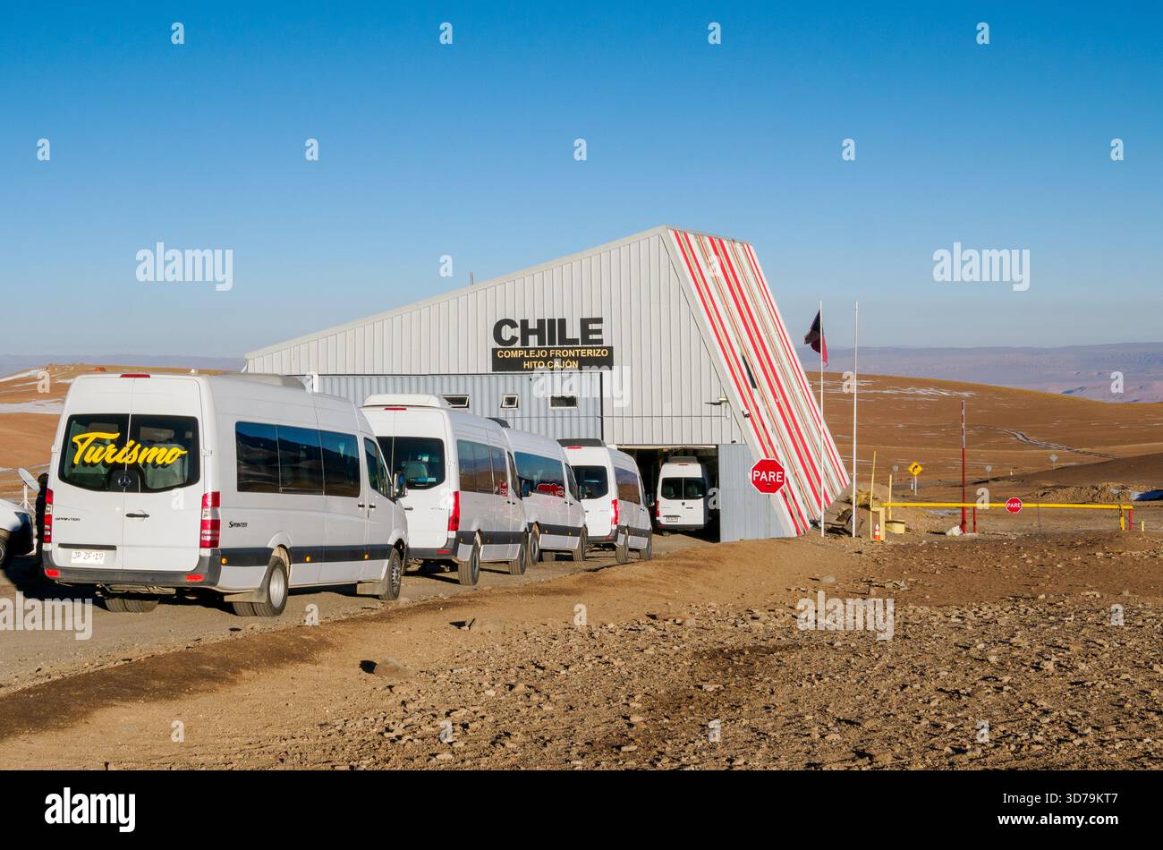 Queue of tourist vans at the Argentinian side of the Chile / Argentina border near San Pedro de Atacama high in the Andes Mountains Stock Photo