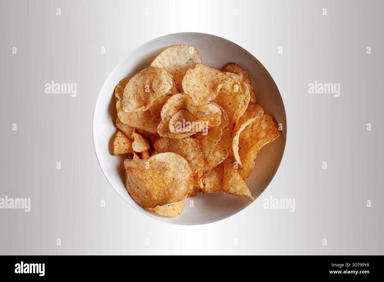 Potato chips in a white bowl Stock Photo