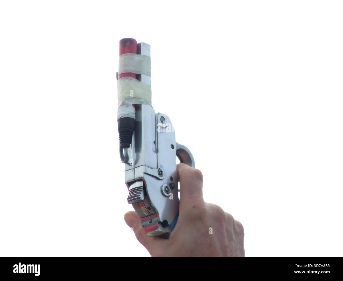 Hand holding an improvised flare gun, preparing to fire a distress signal flare Stock Photo