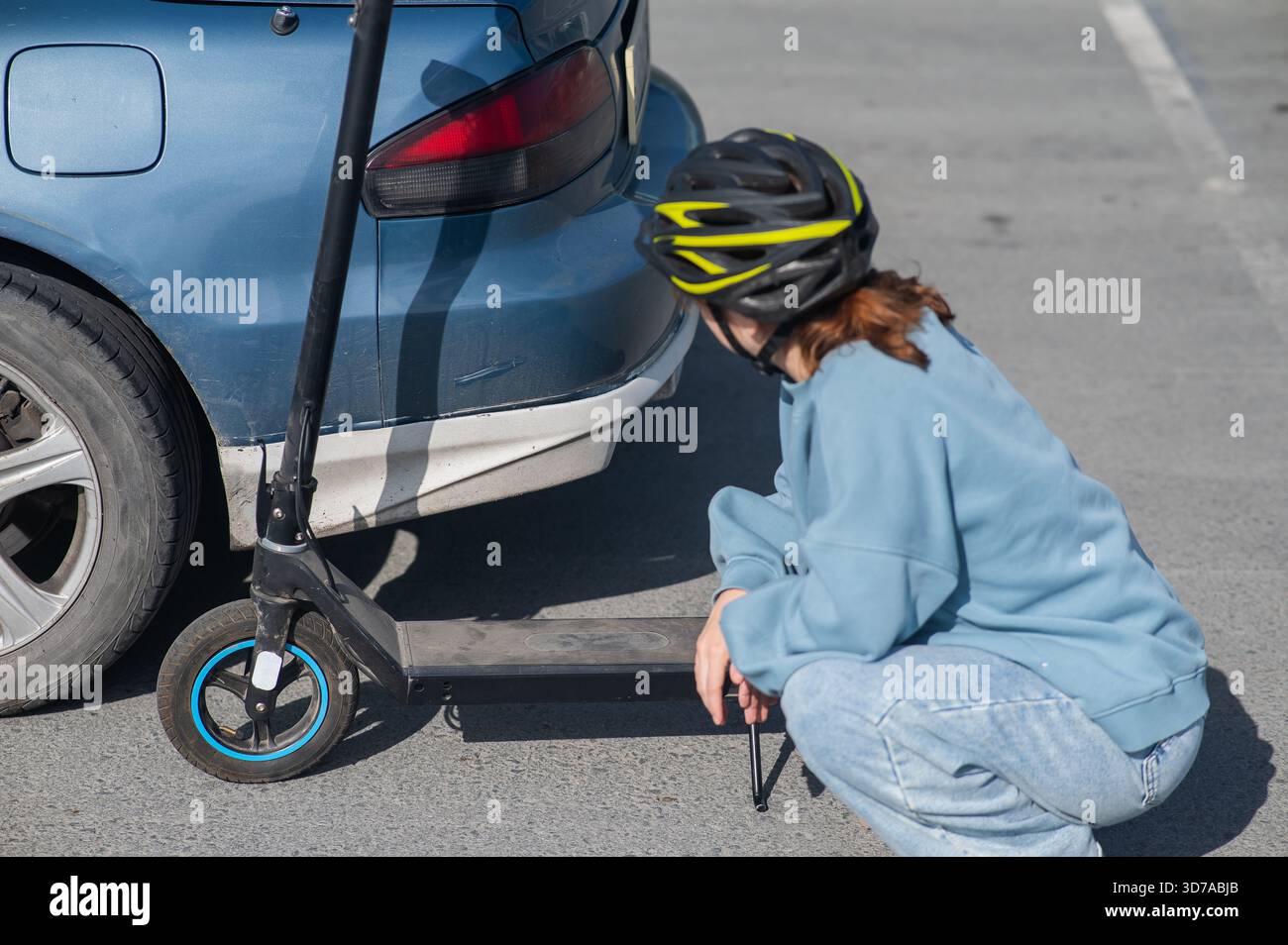 A distressed woman examines the damage after a collision between an ...