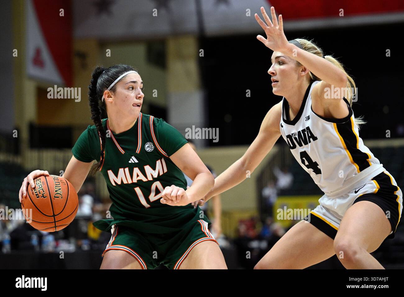 Miami guard Gal Raviv (14) is defended by Iowa guard Kylie Feuerbach (4 ...